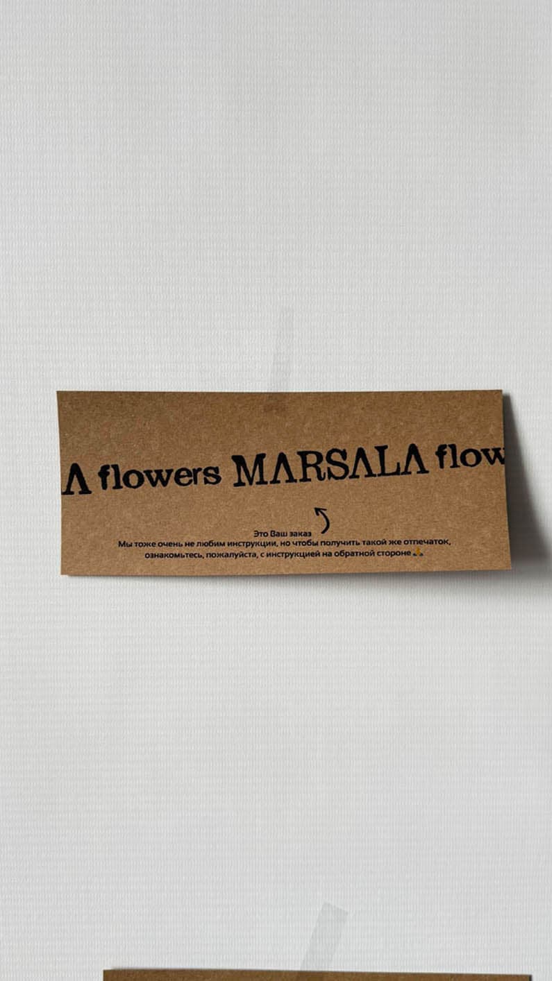 Single-line brand wordmark repeating on a kraft proof card
